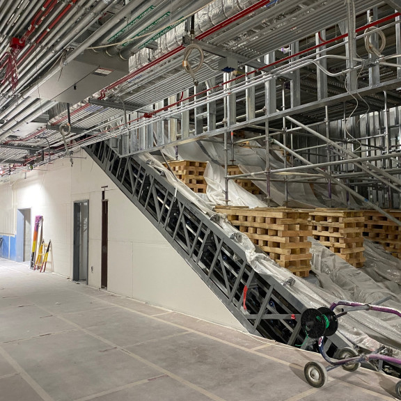 Tunnel drywall finishes under escalators December 2023