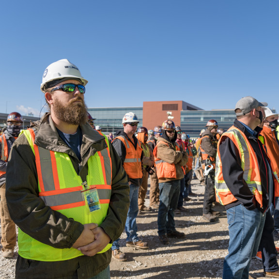 Workers listening at Concourse A East Topping Out ceremony October 13 2021
